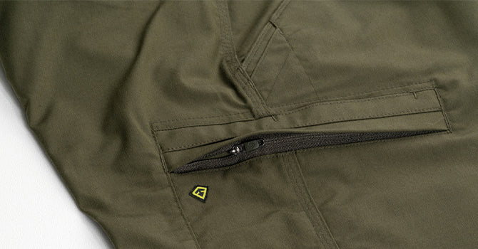 The discreet zippered cargo pockets feature an integrated rain cover, lanyard loop, and internal organization ensuring all your kit is secure without adding a bulky appearance.