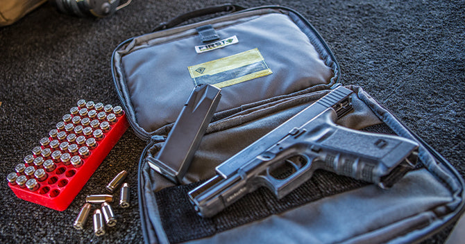 Secures a pistol safely in slash pocket away from the compartmentalized hook/loop organizer.
